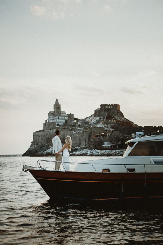 Elopement couple with Porto Venere in the background after their ceremony on a boat