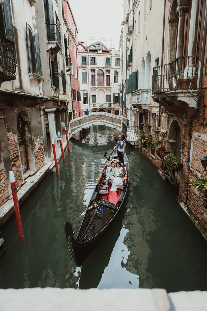 Wedding couple on a gondola in Venice during their elopement