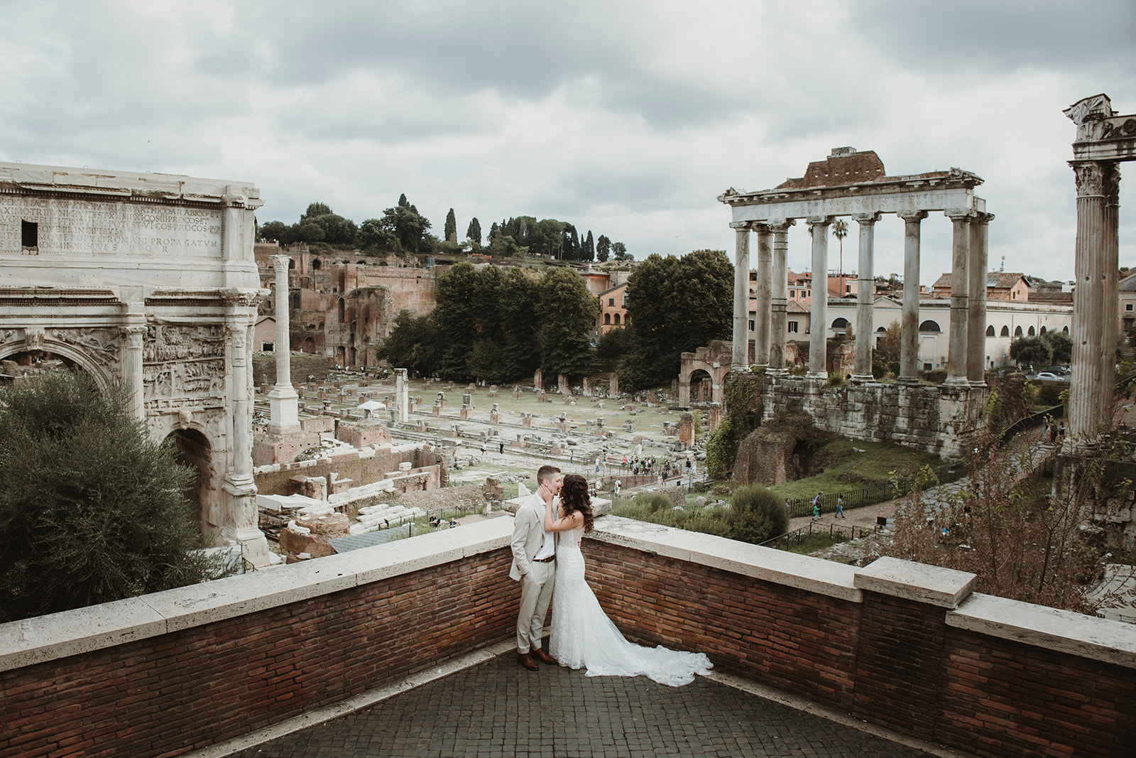 Couple Kissing in front of ancient ruins in Rome during their elopement in Italy