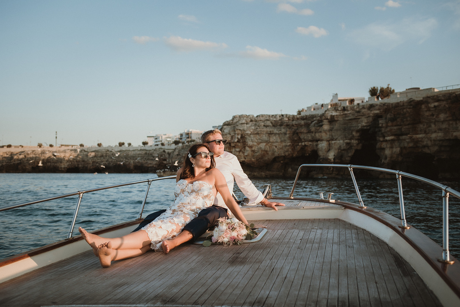 Couple enjoying sunset on a private boat tour during their elopement in Apulia