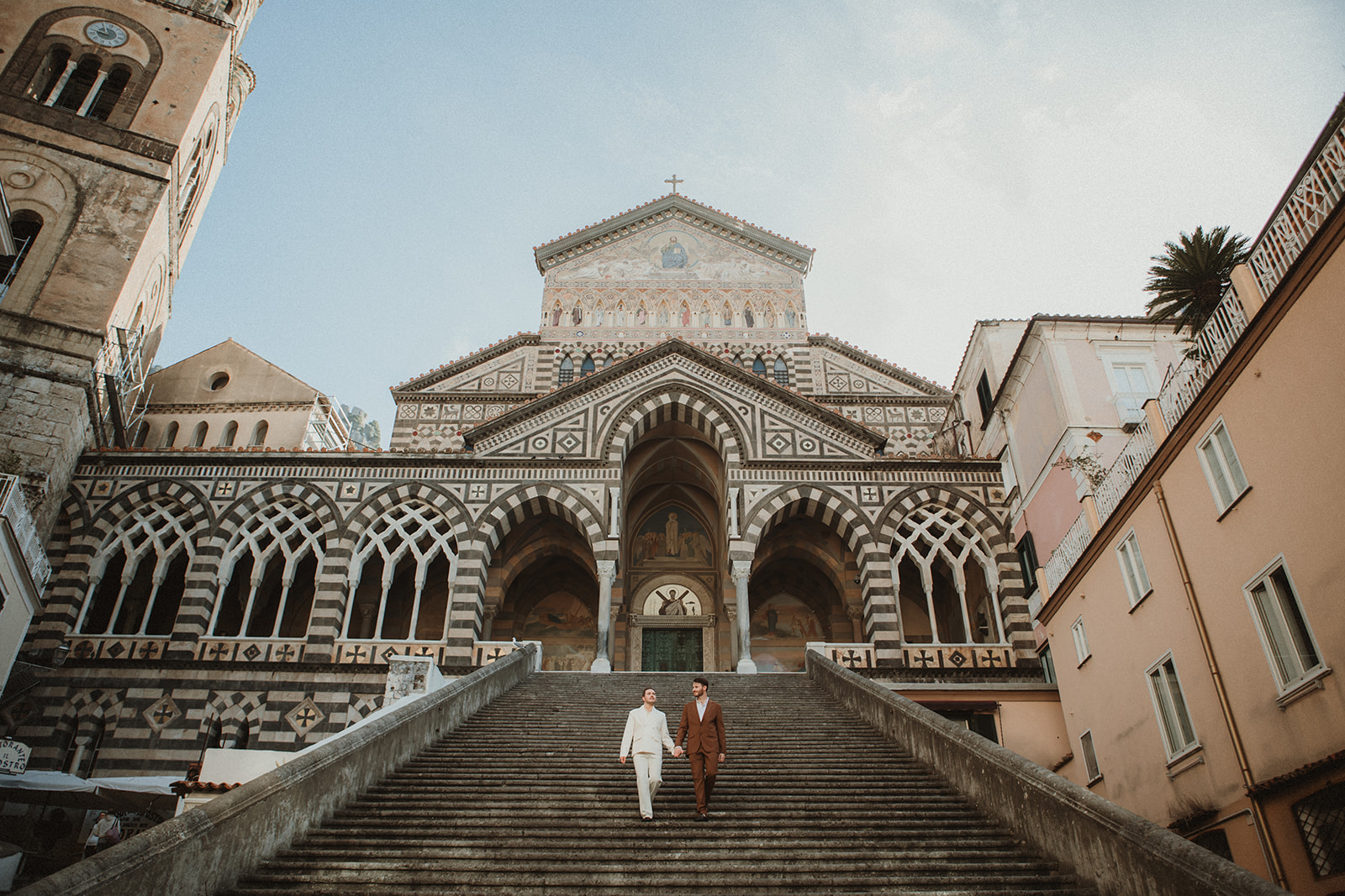 Queer couple standing in front of Duomo di Amalfi during their elopement in the Amalfi Coast