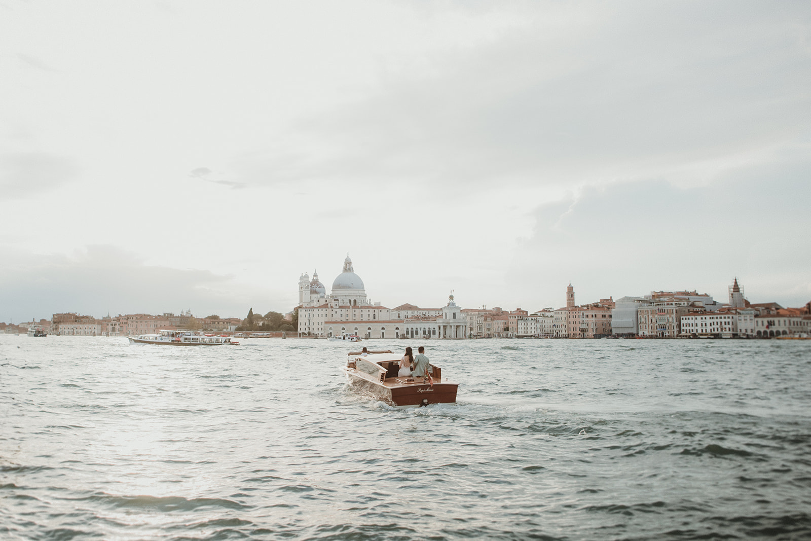 Couple sailing off at sunset in Gran Canal in Venice for their Italy elopement