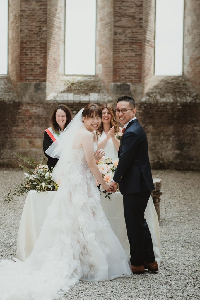 Bride and Groom laughing during their civil ceremony at San Galgano on their elopement in Tuscany