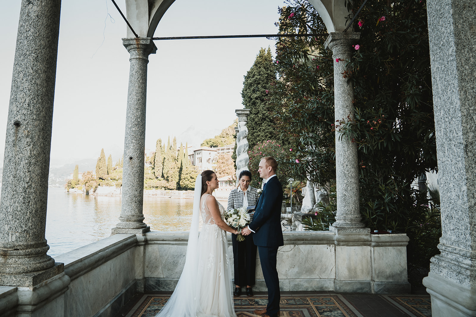 Emotional Couple holding hands during their symbolic ceremony at Villa Monastero for their Lake Como Elopement