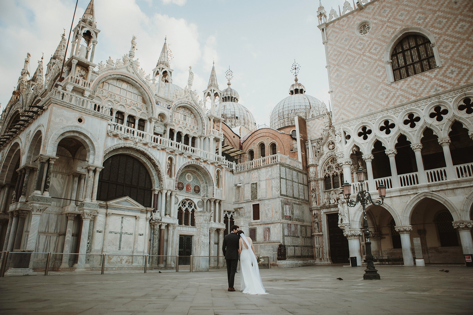 Couple having a sweet moment in front of San Marco during their dawn elopement in Venice