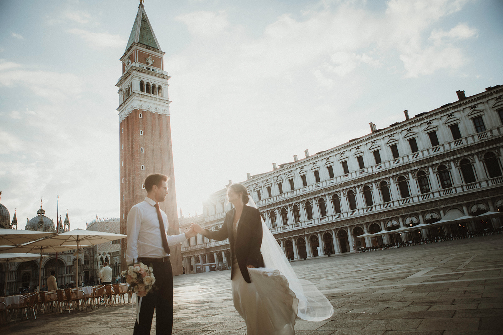 Couple laughing at dawn in Venice in Piazza San Marco during their Italy elopement