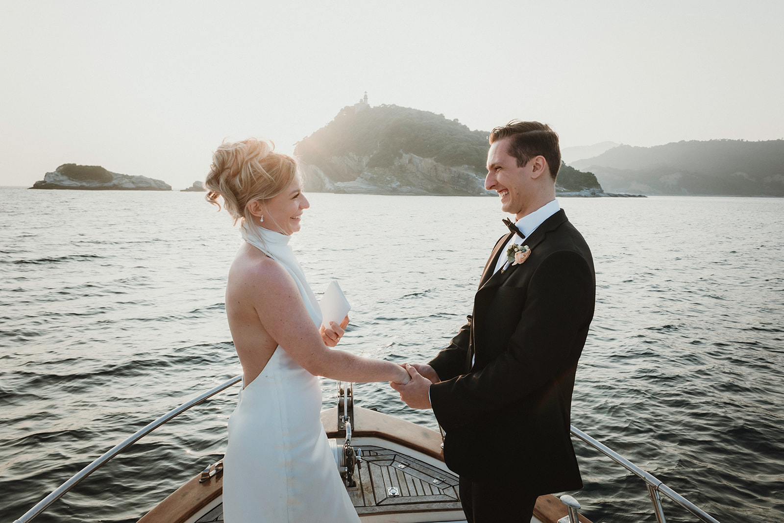 Couple smiling after exchanging their vows on a private boat at sunset for their elopement in Cinque Terre