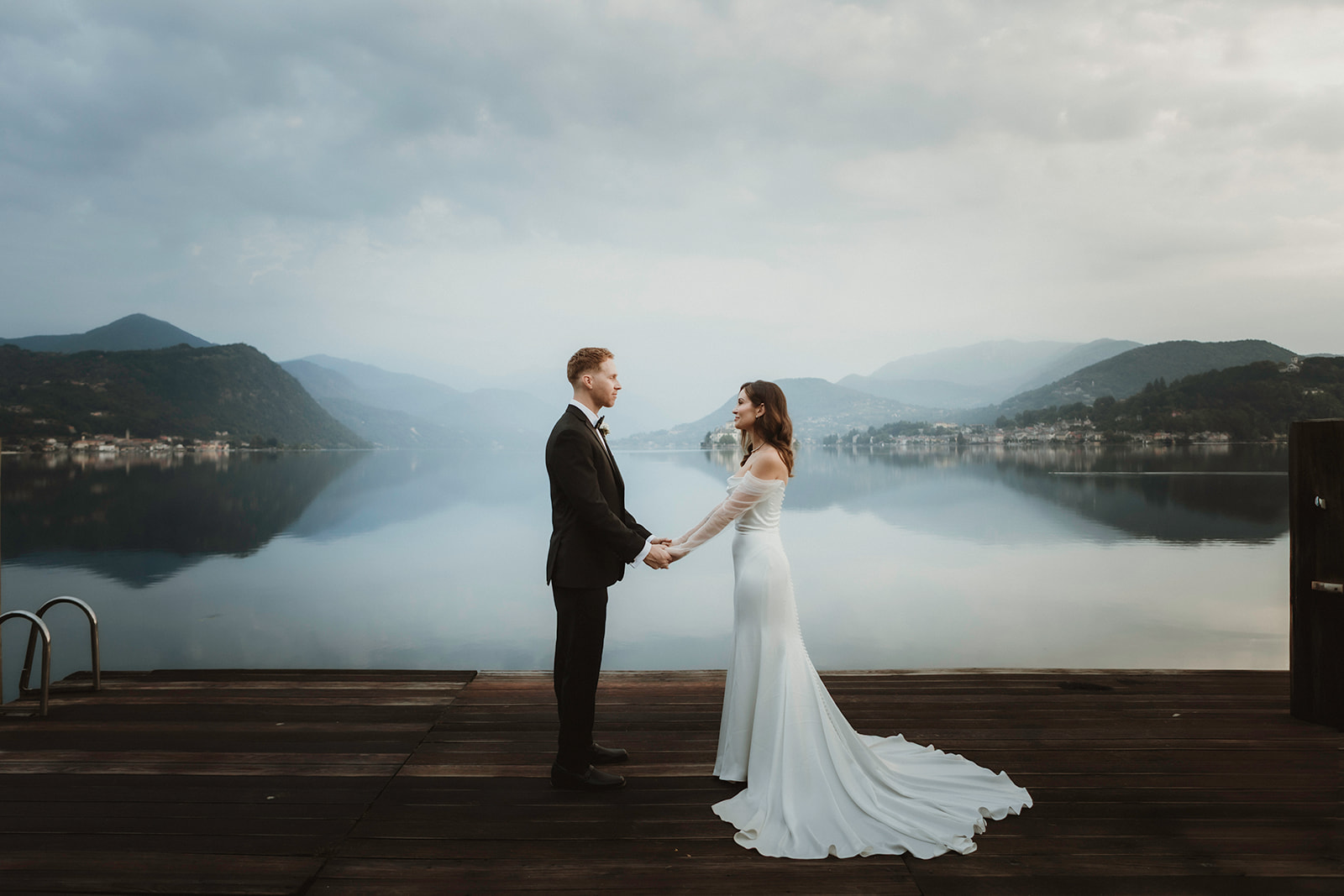 Couple exchanging vows with dramatic lake views during their sunrise elopement on Lake Orta, Italy