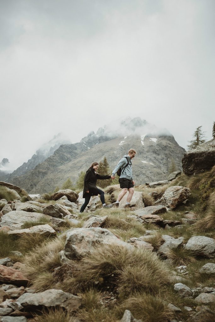 Couple hiking toward a hidden glacier lake in the Aosta Valley during their adventure elopement in Italy.