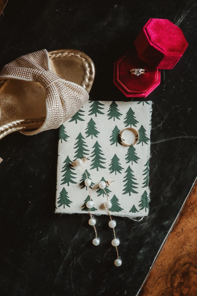 Detail shot of elopement rings and bouquet with natural alpine textures during a mountain elopement in Italy.