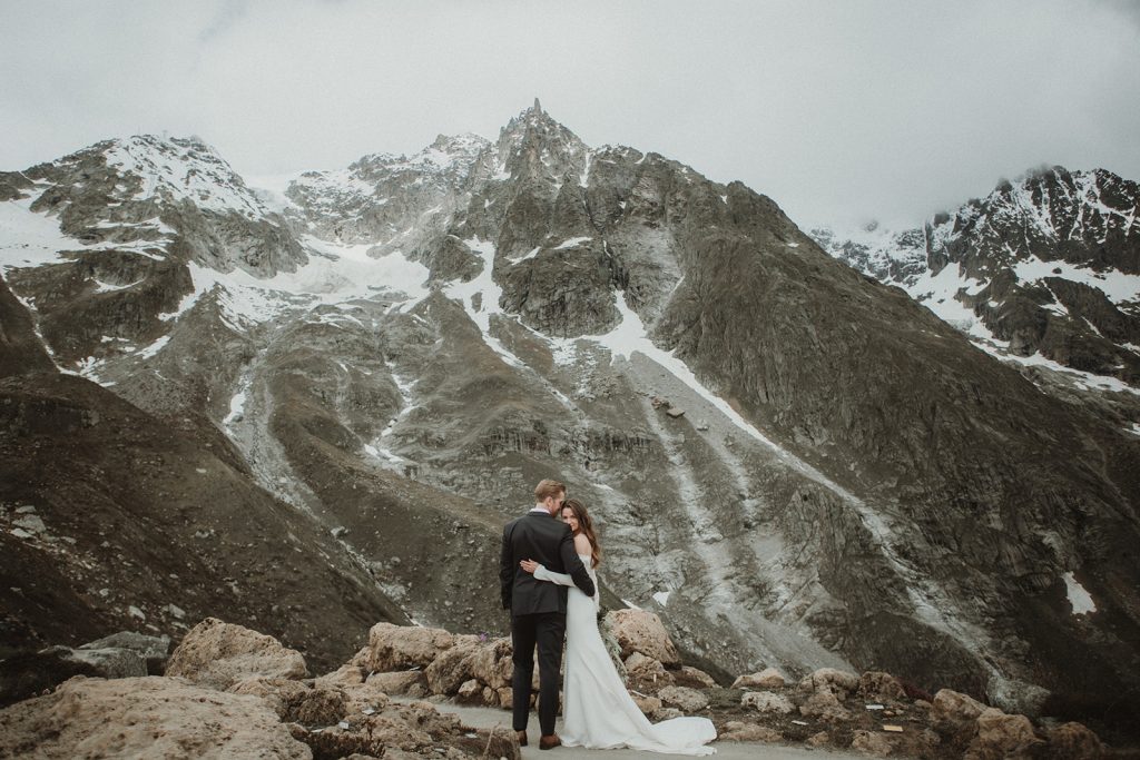 Intimate portrait of the couple with glacier and alpine peaks in the background during their Aosta Valley elopement.
