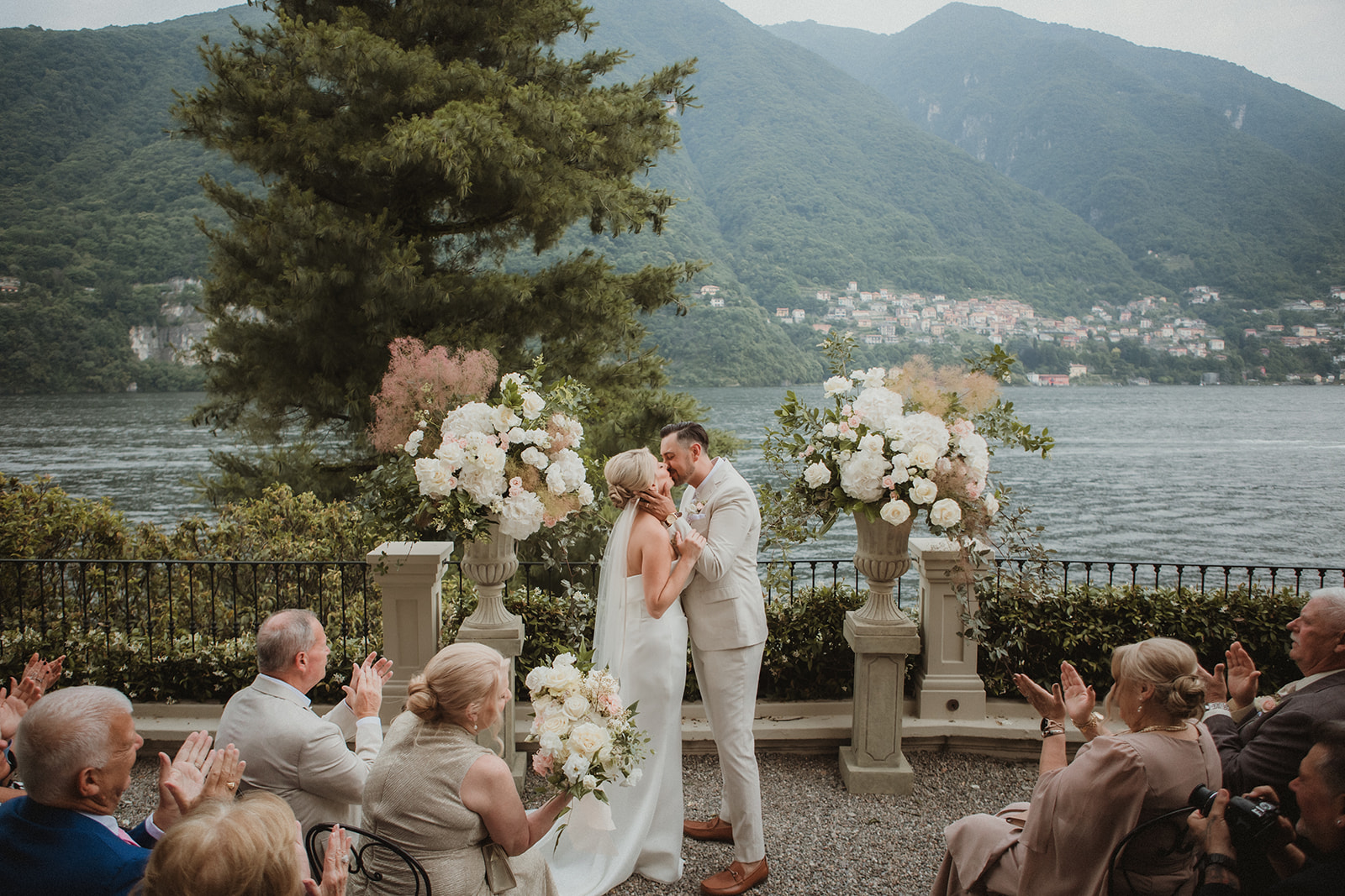Couple kissing during their intimate ceremony on Lake Como