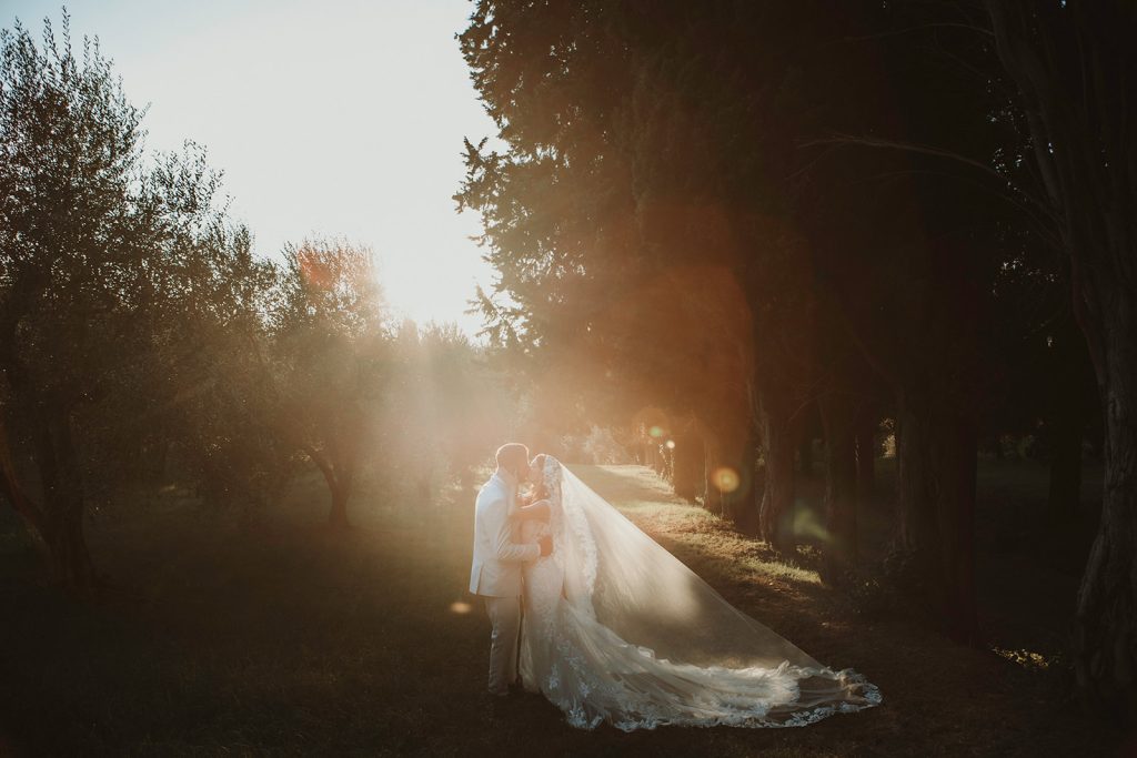 Couple kissing at sunset in a luxury Villa in Tuscany on their small wedding
