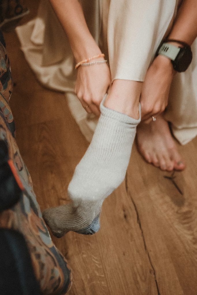 Couple preparing for sunrise vow exchange in the Aosta Valley, Italy during their mountain elopement