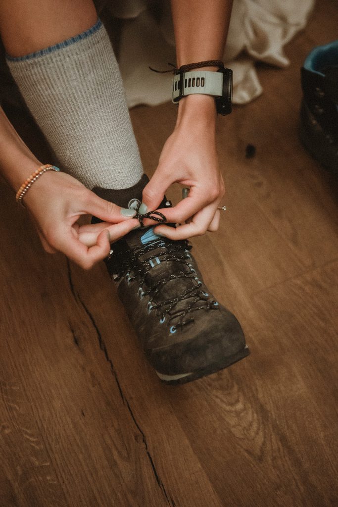Couple preparing for sunrise vow exchange in the Aosta Valley, Italy during their mountain elopement