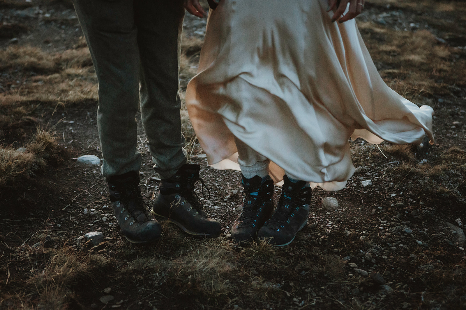 Wedding details from a mountain elopement in Italy, including rings, bouquet, and alpine scenery