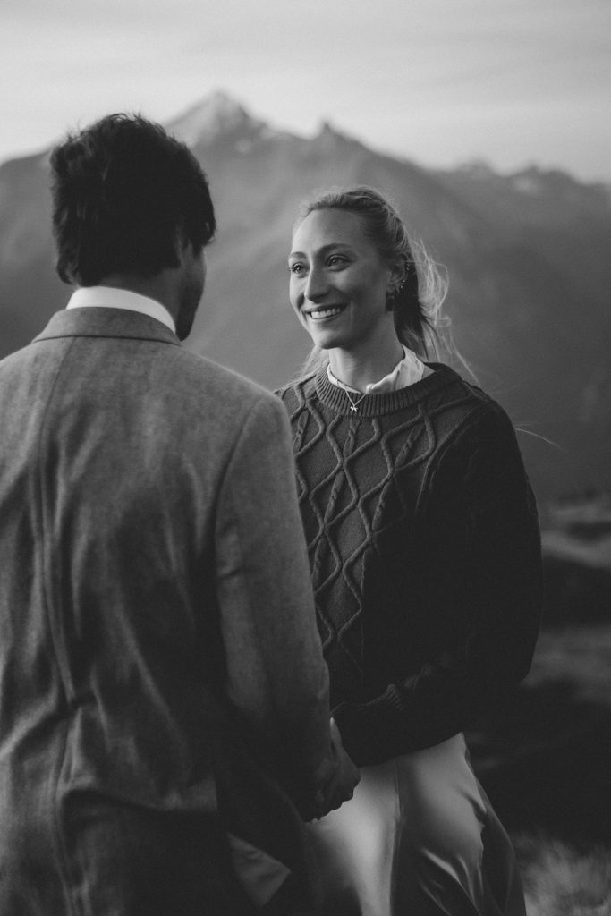 Holly & Loz exchanging vows at sunrise on a mountain in the Italian Alps, intimate mountain elopement