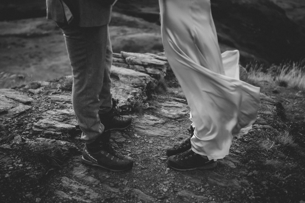 Hiking shoes and gear for a mountain elopement in Italy, emphasizing adventure and alpine setting