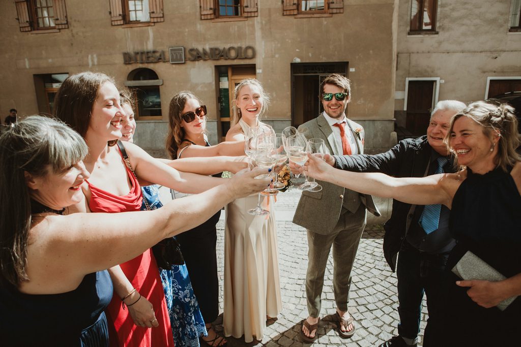 Small gathering of friends and family at Villeneuve town hall for a mountain elopement in Italy.