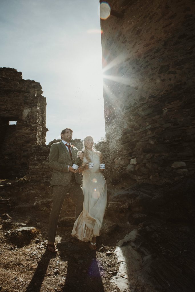 Couple sharing joyful moments at Villeneuve Castle during their Aosta Valley mountain elopement