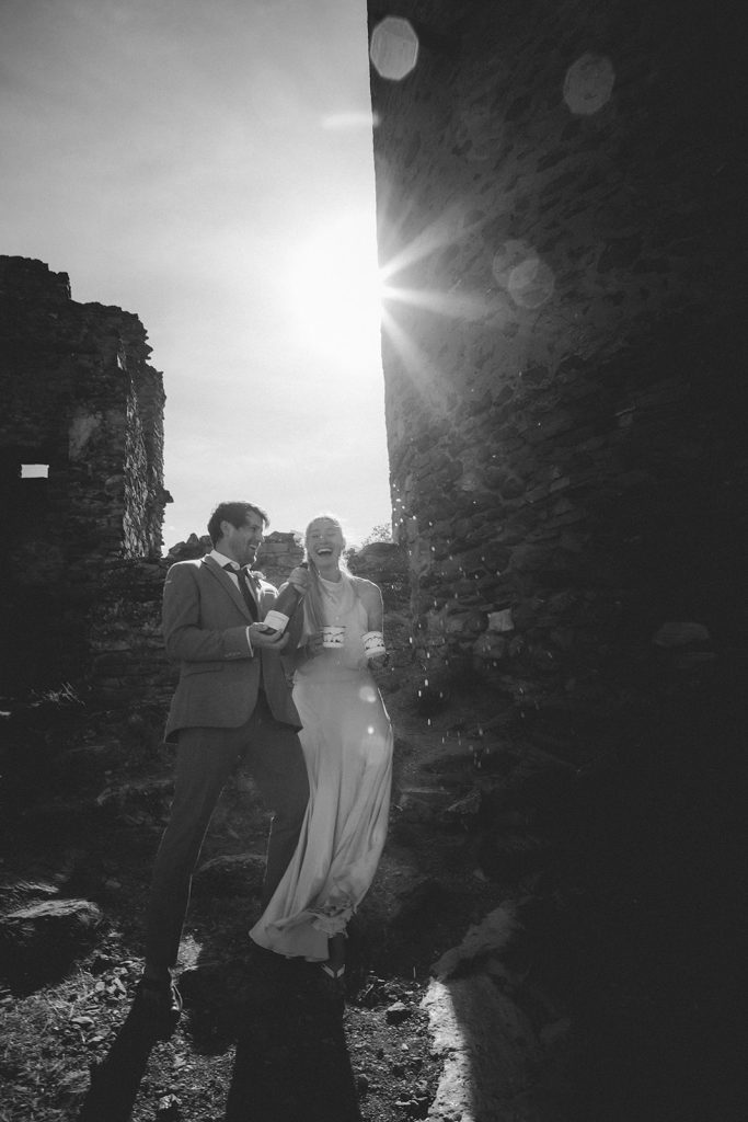 Couple sharing joyful moments at Villeneuve Castle during their Aosta Valley mountain elopement