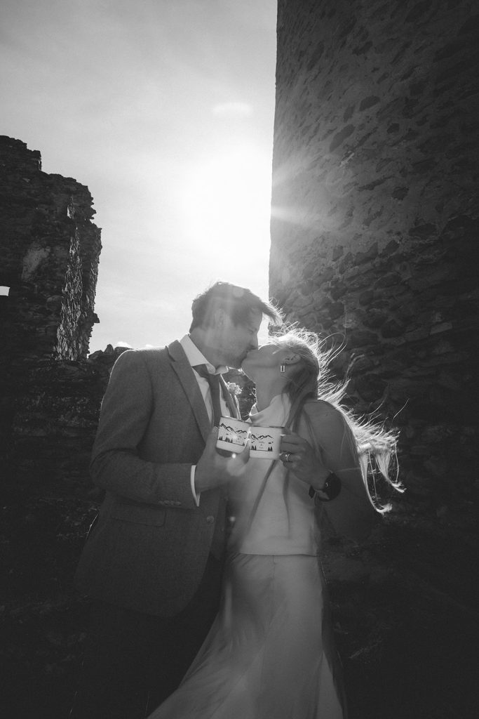 Couple toasting and laughing during the finale of their mountain elopement in the Aosta Valley, Italy