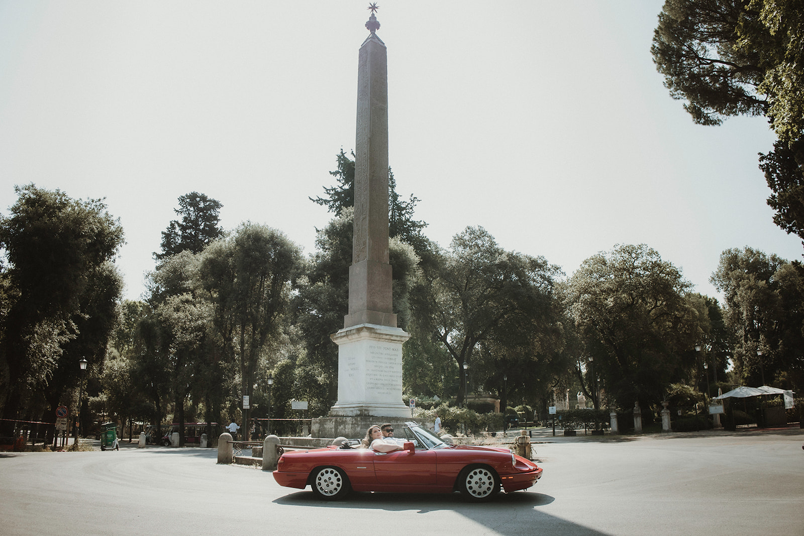 Couple on a vintage Italian car during their elopement in Rome