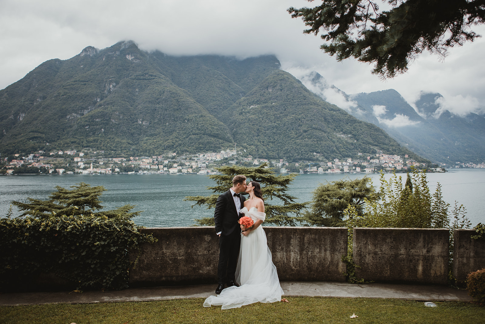 couple kissing with beautiful views of Lake Como in the background on their elopement on Lake Como