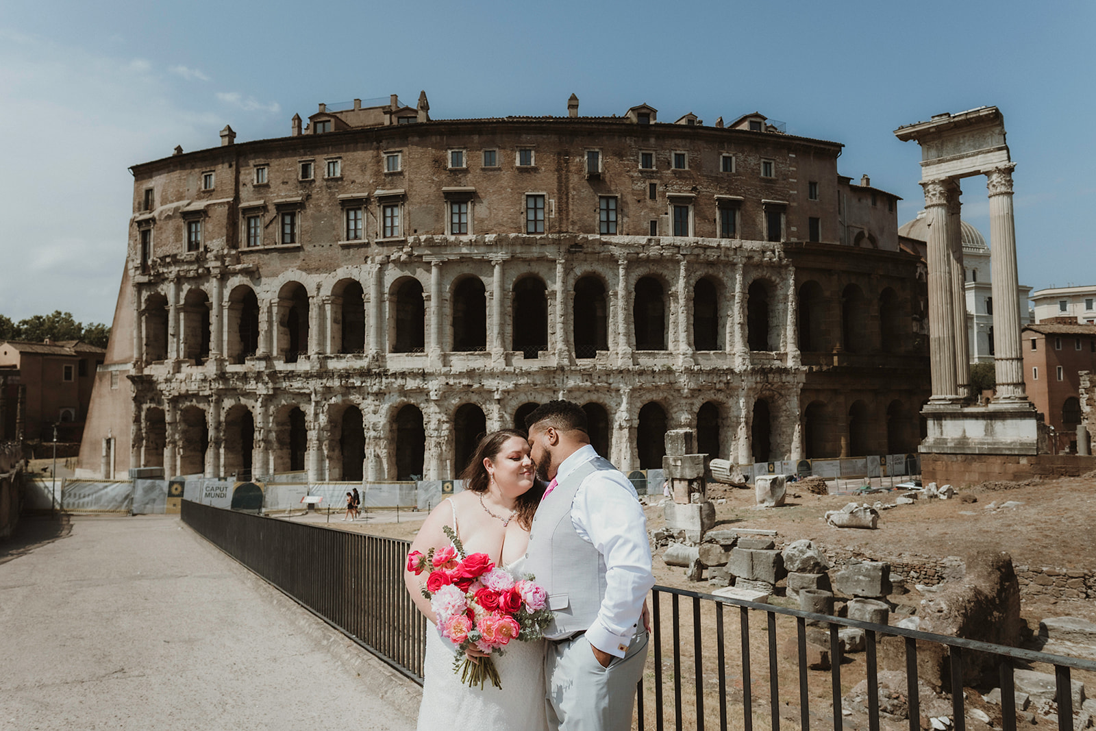 Couple having an intimate moment in front of ancient Roman ruins, on their elopement in Rome