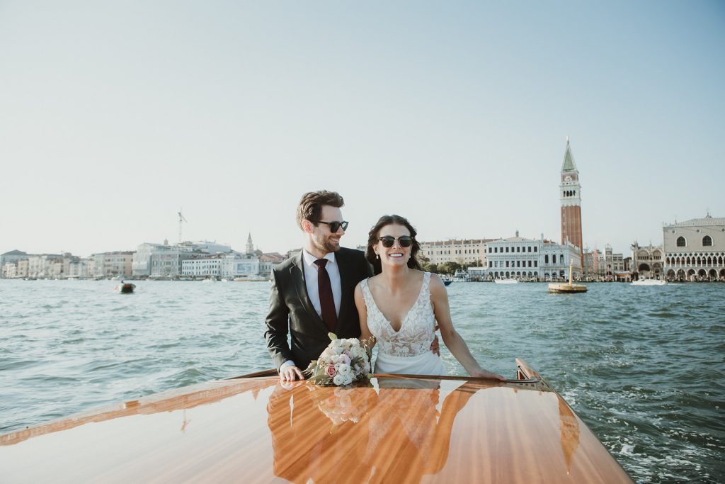 Couple on sunset boat tour in Venice during their elopement in Italy