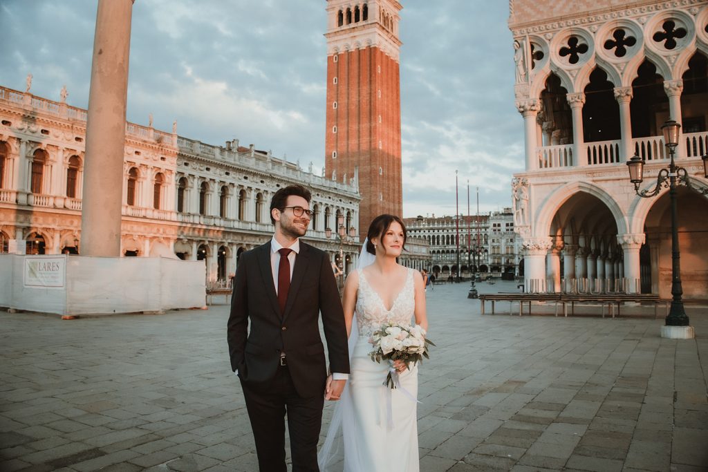 Couple enjoying the first morning light on their sunrise elopement in Venice