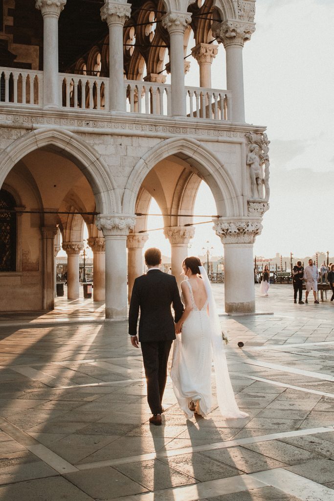 Couple walking candidly in their elopement in Venice