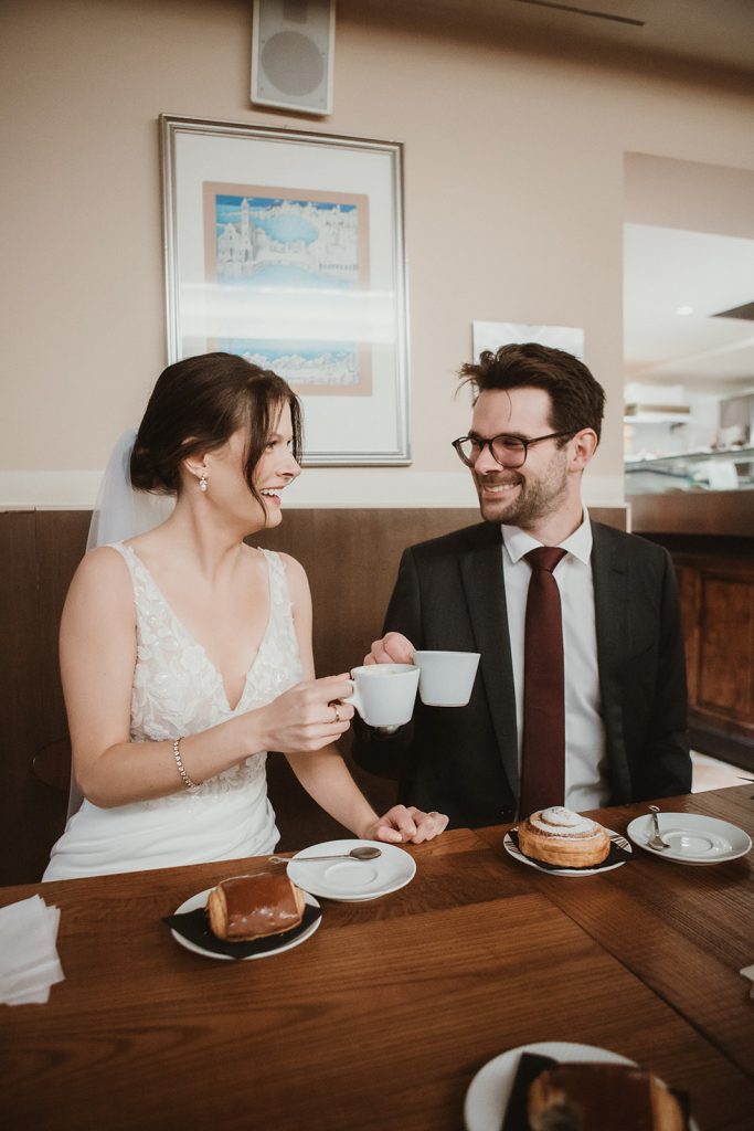 Couple having breakfast in a typical cafeteria on their elopement in Venice