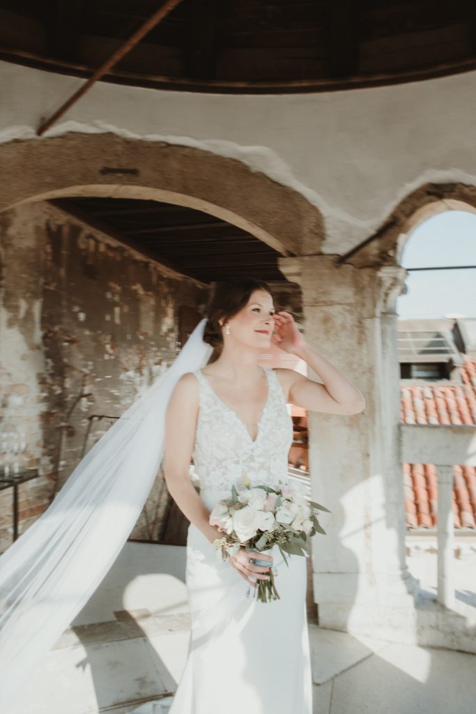 Bride walking towards groom as they are about to start their elopement ceremony in Venice