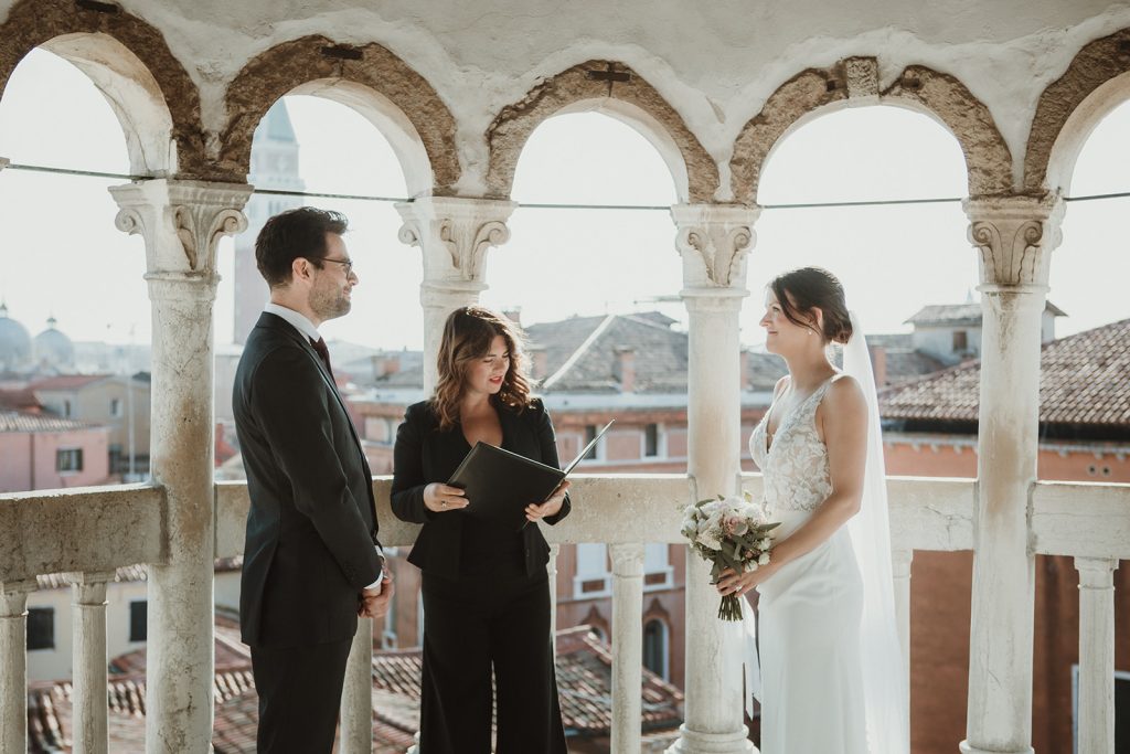 Couple during their intimate symbolic ceremony at Palazzo Contarini del Bovolo on their elopement in Venice