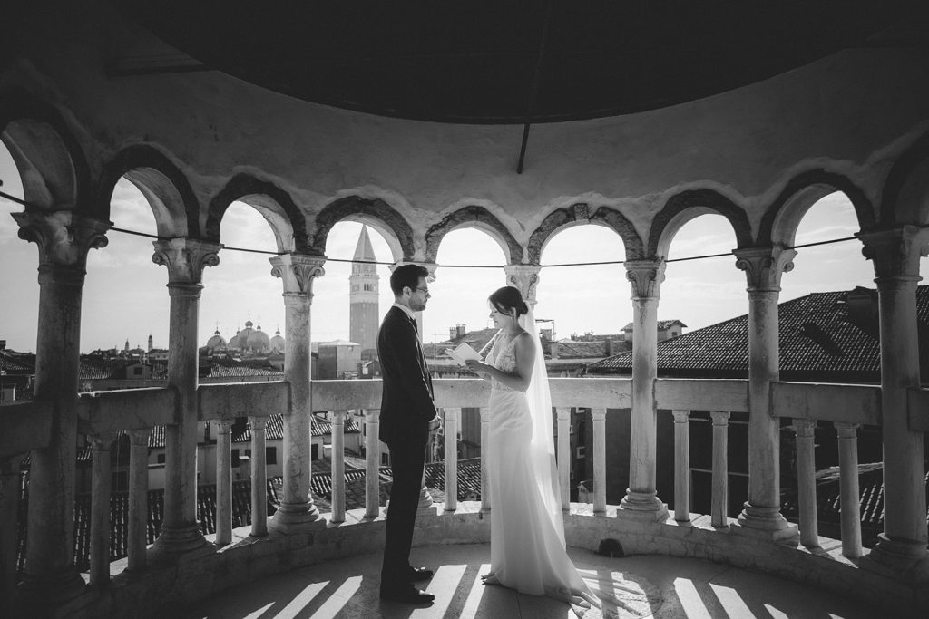 Couple exchaning vows during their symbolic ceremony at Palazzo Contarini del Bovolo