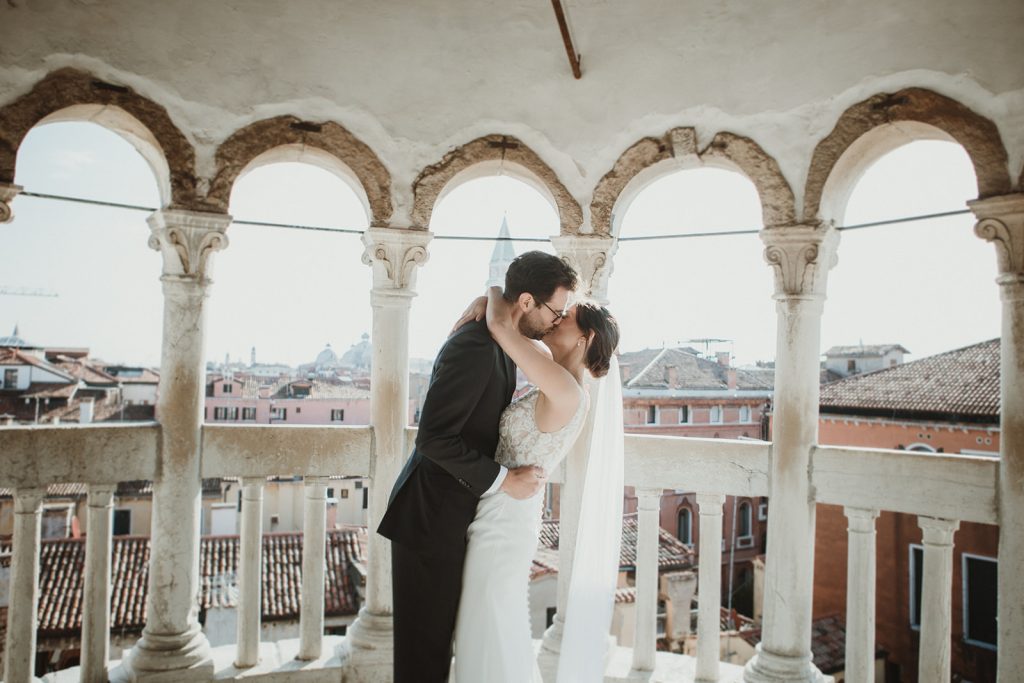 Couple kissing at the end of their symbolic ceremony at Palazzo Contarini del Bovolo