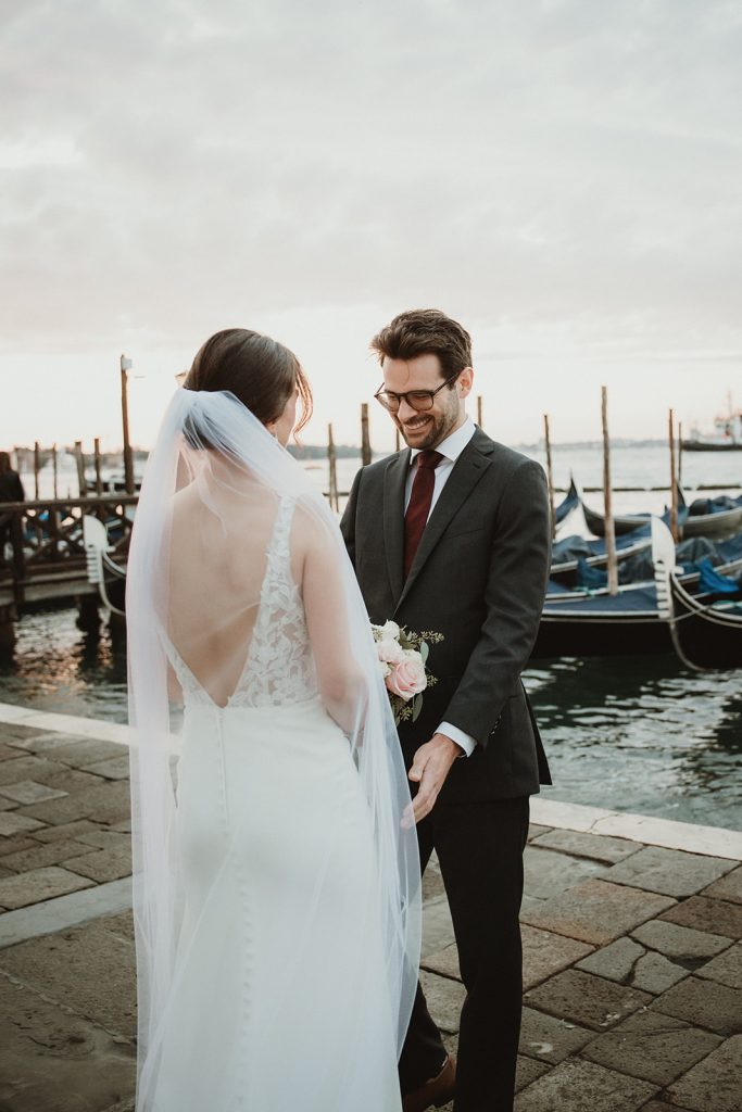 Groom seeing the bride for the first time on their first look in Venice