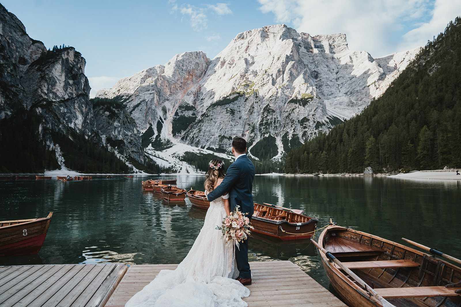 Couple enjoying the serenity of Lake Braies in the Dolomites during their mountain elopement in Italy