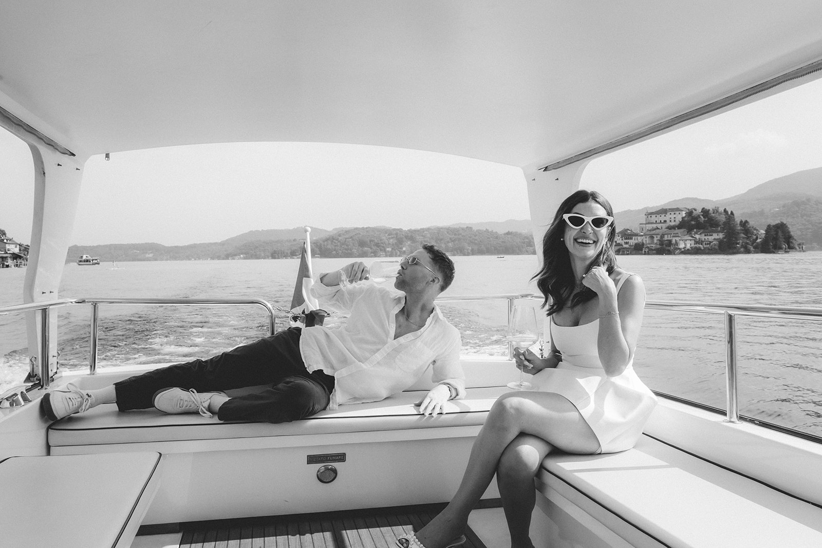 Couple laughing on their boat ride for their elopement in Italy