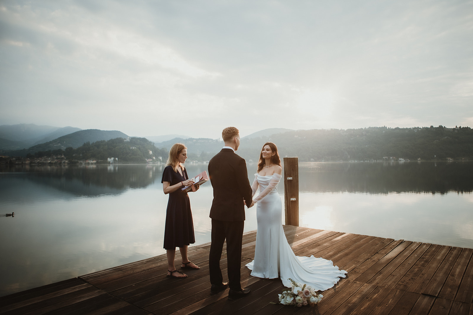 Sunrise Symbolic ceremony by the shores of a Northern Italy lake.
