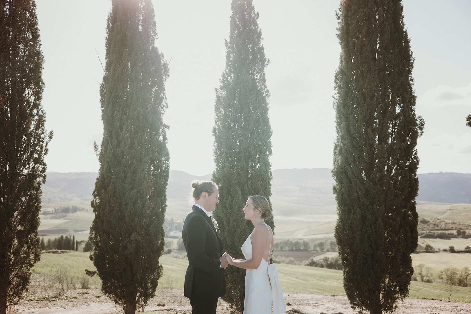 Couple on their elopement symbolic ceremony with Tuscan cypresses
